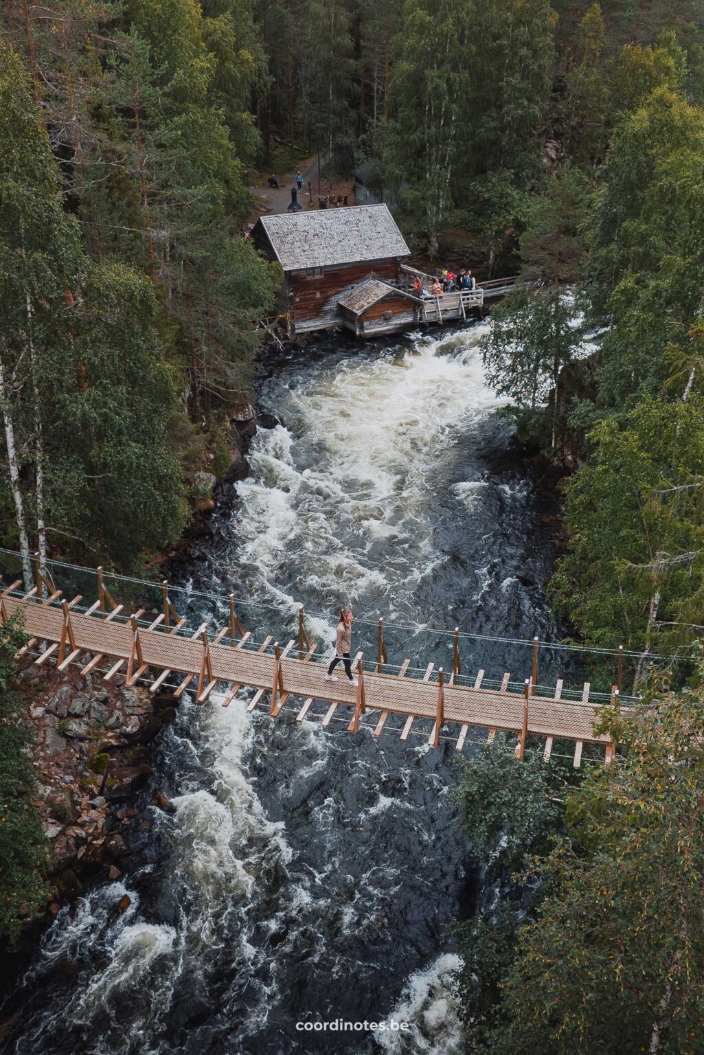Sarah crossing the suspension bridge over the Myllykoski Rapid at Pieni Karhunkierros