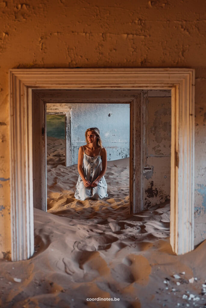 Inside a house, everything covered in sand