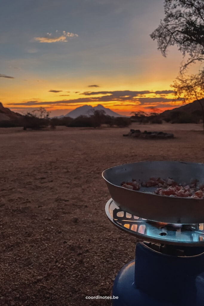 Enjoy the sunset while cooking on a campsite